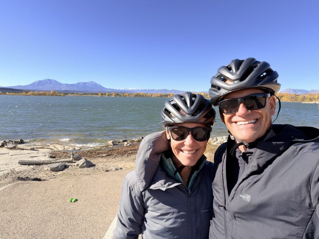 Erin and Matt in matching bike helmets by the water