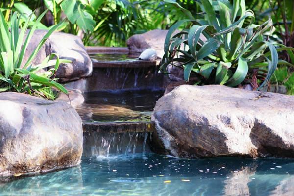 The private stone waterfall pouring into Casa Colorado's black-bottom pool