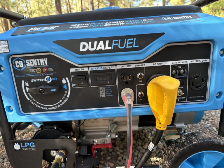 Control panel of a blue Pulsar dual fuel generator with CO Sentry, a yellow 30 amp RV plug connected.